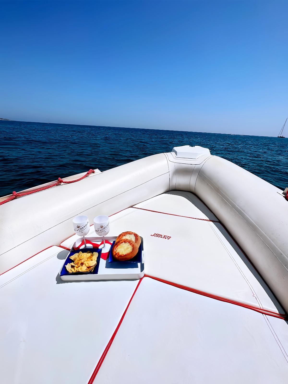 Sunset aperitivo on board with wine and Sicilian platters in Syracuse
